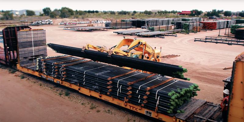 Transloading pipe between truck and rail
